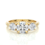 Gold ring with three diamonds on a white background